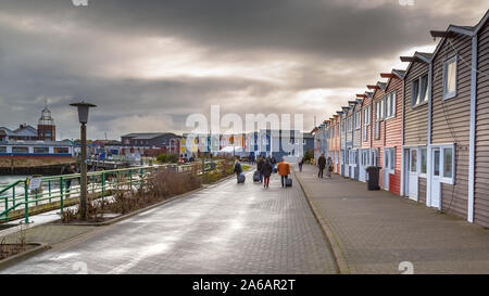 HELGOLAND, GERMANY - DECEMBER 18, 2016: People and shops in the Harbor of Helgoland island on a cloudy day, Germany Stock Photo