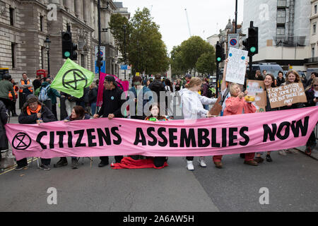 Extinction Rebellion disruption begins as the activists block 12 sites around Westminster on 7th October 2019 in London, England, United Kingdom. Extinction Rebellion is a climate change group started in 2018 and has gained a huge following of people committed to peaceful protests. These protests are highlighting that the government is not doing enough to avoid catastrophic climate change and to demand the government take radical action to save the planet. Stock Photo