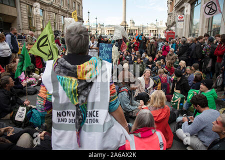 Despite a directive from the police not to gather, Extinction Rebellion take over Whitehall in a sit down protest where large numbers were arrested on 16th October 2019 in London, England, United Kingdom. Extinction Rebellion is a climate change group started in 2018 and has gained a huge following of people committed to peaceful protests. These protests are highlighting that the government is not doing enough to avoid catastrophic climate change and to demand the government take radical action to save the planet. Stock Photo