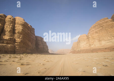 The amazing desert view of sand dunes and mountains in the beautiful Jordanian desert of Wadi Rum on a sunny day. Stock Photo