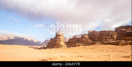 The amazing desert view of sand dunes and mountains in the beautiful Jordanian desert of Wadi Rum on a sunny day. Stock Photo