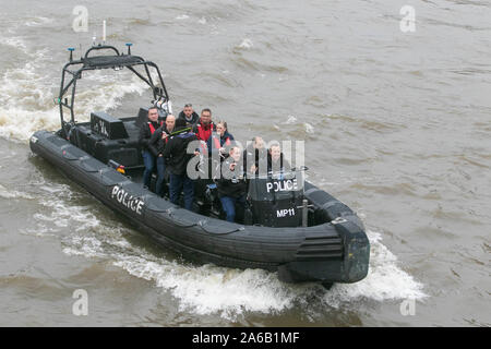 London, UK. 25th Oct, 2019. Passengers on a police patrol dinghy boat navigating on River Thames in London. Credit: ZUMA Press, Inc./Alamy Live News Stock Photo