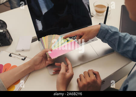 Graphic designer at work. Color swatch samples. Stock Photo