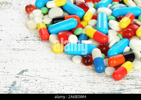Close up of different color pills on old wooden background close-up Stock Photo