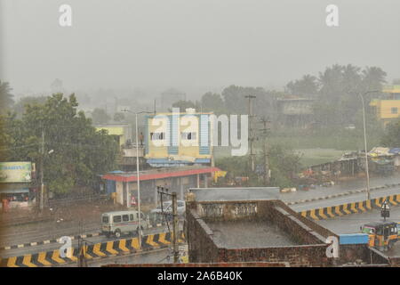 The image of a rain cloud and falling rain. rain drops falling on the ground in the town Stock Photo