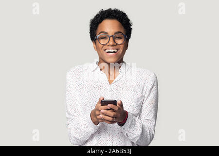 Head shot excited African American girl using phone, having fun Stock Photo