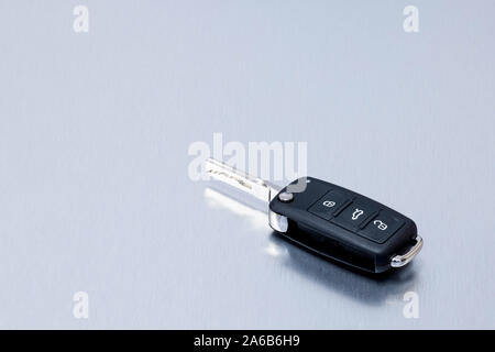 New remote vehicle key fob on aluminium background. Repair of broken or damaged remote key fob of any vehicle car service.- Image Stock Photo