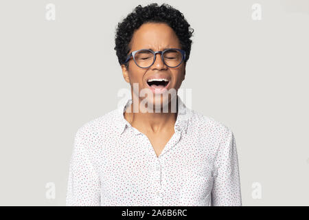 Head shot angry stressed African American woman screaming Stock Photo