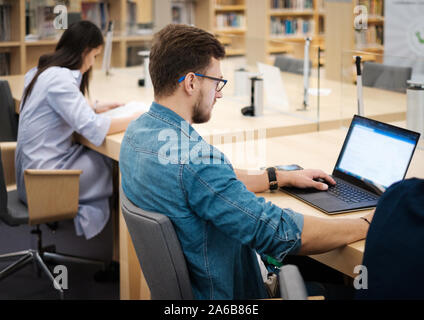 Students studying in a public library. Stock Photo