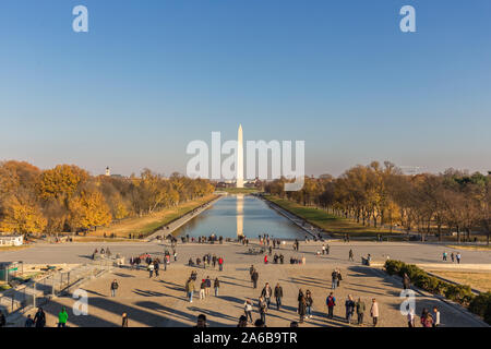 Sunset view of the Washington Monument with golden sunlight and the Lincoln Memorial Reflecting Pool Stock Photo