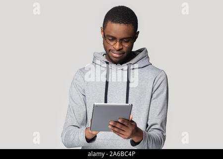 Head shot African American man in glasses using computer tablet Stock Photo