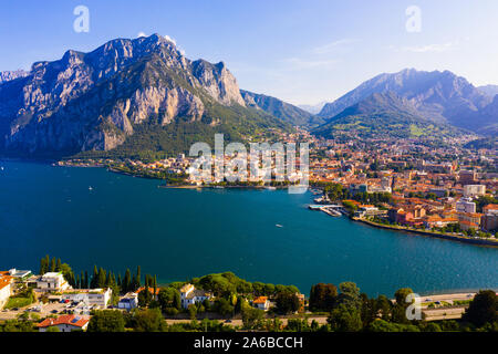 Colorful mountain scenery with Italian city of Lecco on shore of picturesque Lake Como on sunny day, Italy Stock Photo