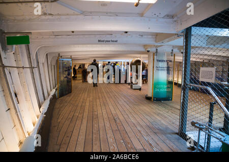 'Tween Deck - cargo deck space - of the sailing ship the Cutty Sark. Greenwich, London UK.  Tween Deck: 'tween' is a colloquial abridging of the word 'between'. In a ship the tween deck actually means an empty space separating two decks or between (tween) two other decks in the hull of a vessel. Stock Photo