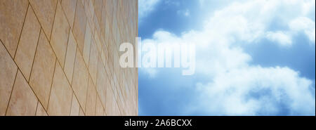 New modern ventilated stone wall made with different blocks of rectangular shape with wide joints against a sky background - image with copy space Stock Photo