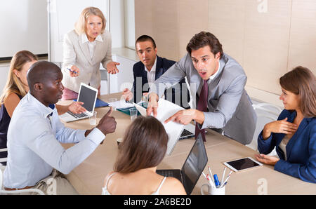 Multiethnic business team having emotional discussion on staff meeting at office Stock Photo