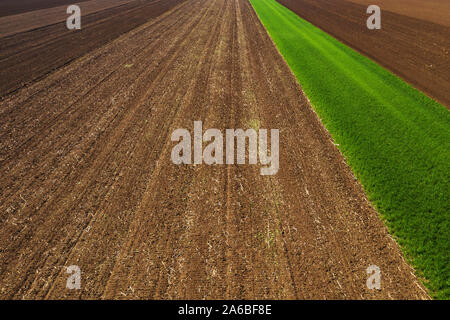 Aerial view of ploughed agricultural field in perspective, high angle view of arable land Stock Photo