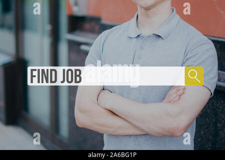 The concept of job search on the Internet. String for entering data on the background of a young man in a t-shirt. Stock Photo