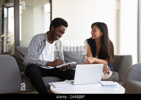 Diverse colleagues working on online project together, discussing ideas Stock Photo