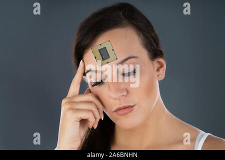 Thinking Female With Computer Chip Implant In Her head Stock Photo