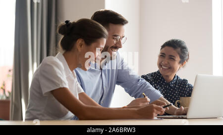 Multiracial laughing positive team having fun in office Stock Photo