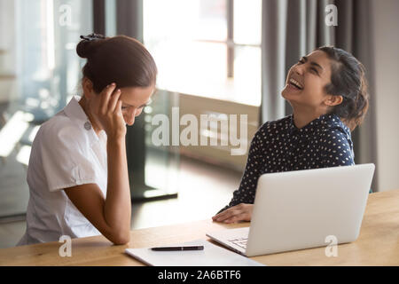 Happy young multiracial team having fun at office. Stock Photo