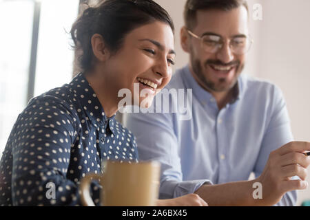 Diverse office workers couple having a coffee break Stock Photo