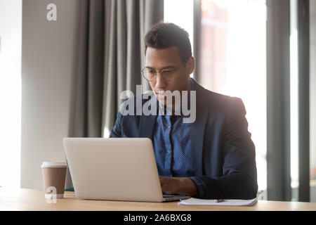 Serious african american employee working with computer at office Stock Photo