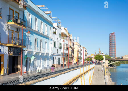 Coloured houses along the Triana banks of the Guadalquivir river with the Seville tower behind Sevilla Seville Spain seville Andalusia Spain EU Europe Stock Photo