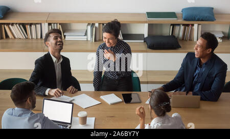 Millennial diverse team having fun at meeting in office. Stock Photo