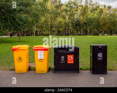 General waste and recycle rubbish bins beside a garden in a public ...