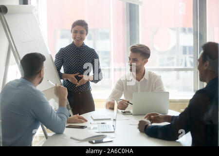 Young happy multiracial team positive working process Stock Photo