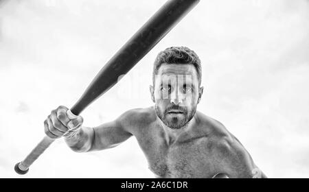 Violence and attack. Street fight. Attack and defence. Get ready attack. Man with baseball bat. Hooligan hits bat. Victory requires payment in advance. Bandit aggression anger. Muscular man fighting. Stock Photo