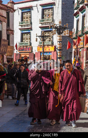 Young Tibetan Buddhist monks circumambulating around the Jokhang Temple kora or circuit in Lhasa, Tibet. Stock Photo