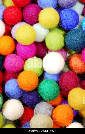 background of felt balls for sale as christmas ornaments Stock Photo