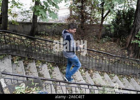 Young man using his mobile in the street Stock Photo