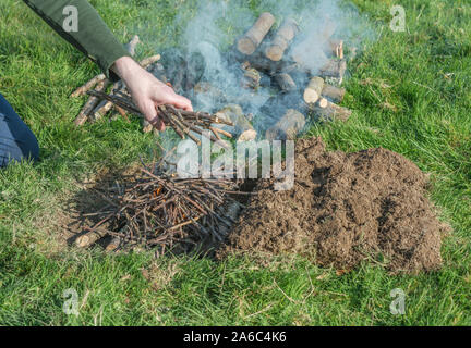 Sequential series of building and lighting survival fire or camp fire. Emergency fire, prepping, survival skills. See additional explanatory NOTES. Stock Photo