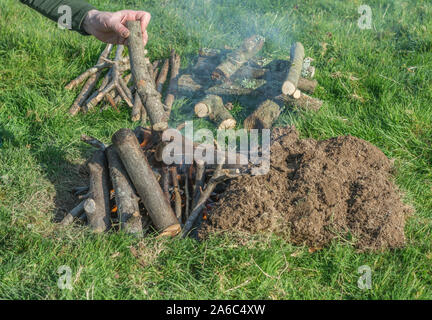 Sequential series of building and lighting survival fire or camp fire. Emergency fire, prepping, survival skills. See additional explanatory NOTES. Stock Photo