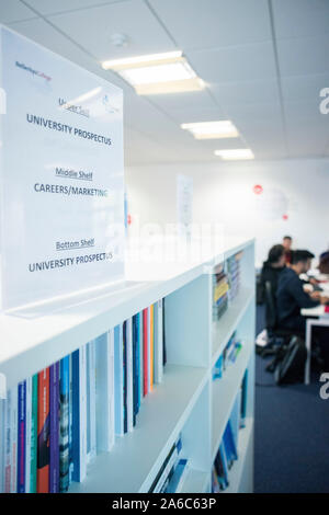 International students reading and working in the college library Stock Photo