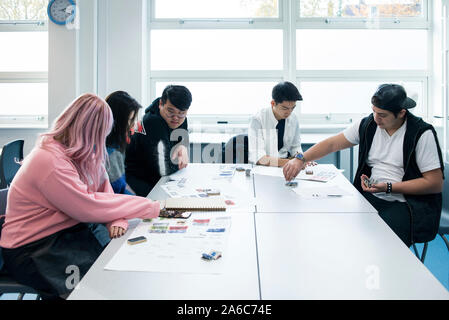 International students in art class study at a table Stock Photo