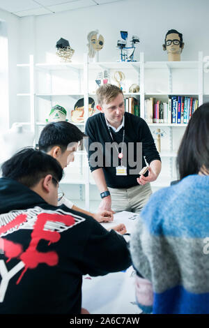 International students in art class study at a table Stock Photo