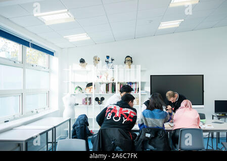 International students in art class study at a table Stock Photo