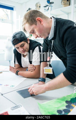 International students in art class study at a table Stock Photo