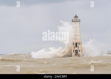Waves crash into the Frankfort North Breakwater Lighthouse in Frankfort, Michigan, USA. Stock Photo