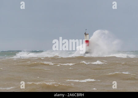 Waves crash into the Frankfort South Breakwater Light in Frankfort, Michigan, USA. Stock Photo