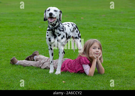 Portrait of a little girl with a Dalmatian. Stock Photo