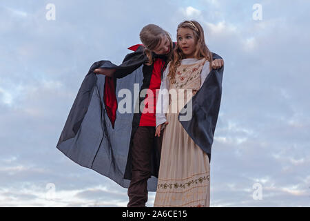 Two young girls are playing Count Dracula. Stock Photo