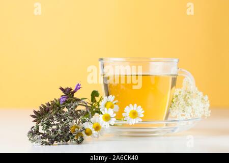 Tea, or infusion, with healing herbs such as camomile, sage, thyme and elderflower. Stock Photo
