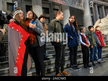 Vancouver, Canada. 25th Oct, 2019. Thousand gather in downtown Vancouver, British Columbia during a rally as 15 plaintiffs, ages 7-19, who launch a lawsuit today against the Canadian government for their personal injuries as a direct result of the climate change stand and look at the crown. Credit: Robin Loznak/ZUMA Wire/Alamy Live News Stock Photo