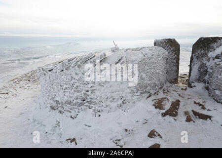 Dry stone wall covered in hoar frost on Whernside carpeted in snow and ice mid winter Yorkshire Dales Stock Photo