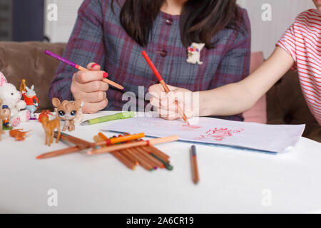 professional psychologist with a teenage girl. Disclosing a child through a drawing. The method of work of a child psychotherapist. Stock Photo